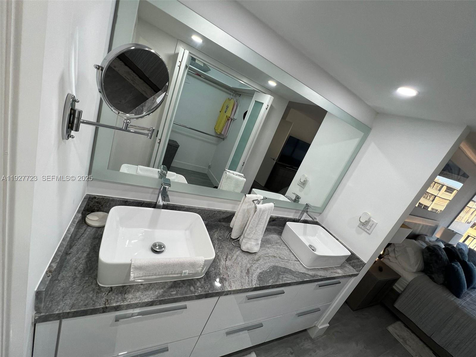 1865 Brickell Avenue, Unit A1607 Miami, FL 33129 - Photo 12 of 15 a bathroom with a sink and mirror