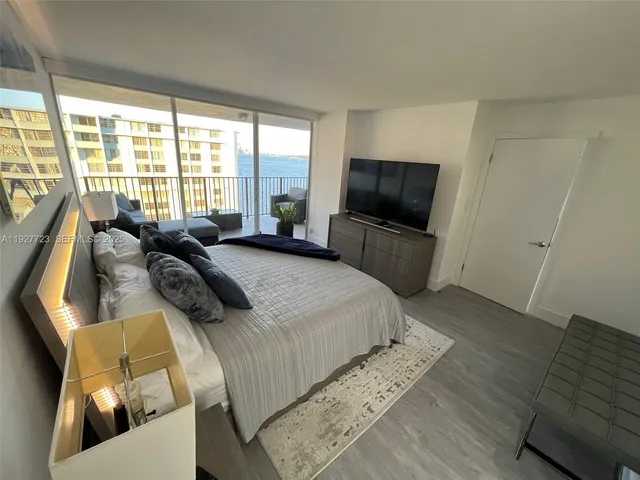 a bedroom with furniture and a flat screen tv