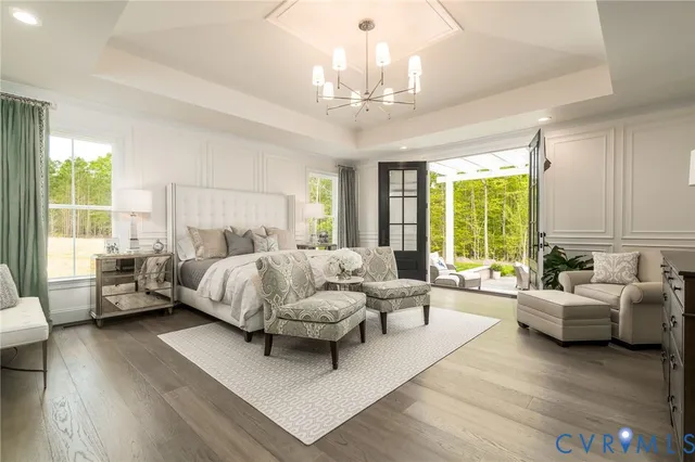 a spacious bedroom with furniture and a large window