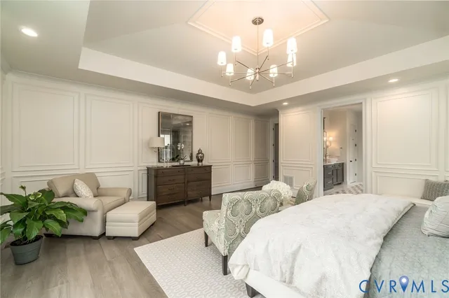 a spacious bedroom with a bed and ceiling fan