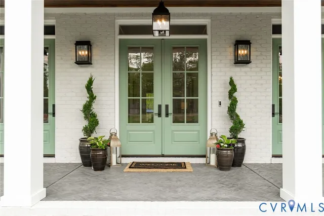 a front view of a house with a potted plant