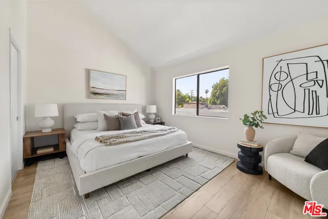 a bedroom with bed and a couch