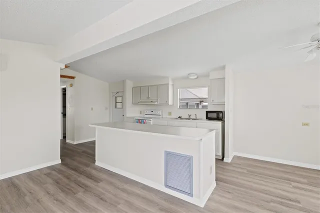 a kitchen with stainless steel appliances white cabinets and a refrigerator