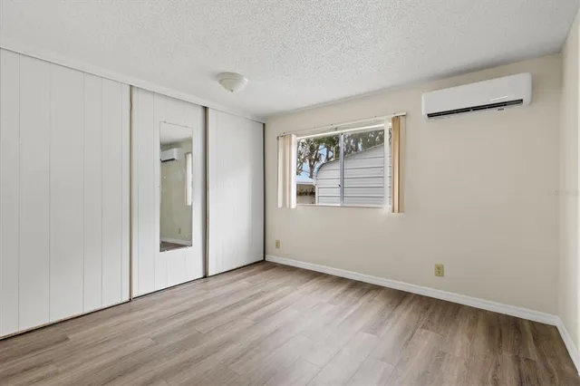 a bathroom with a granite countertop sink and mirror with bathtub