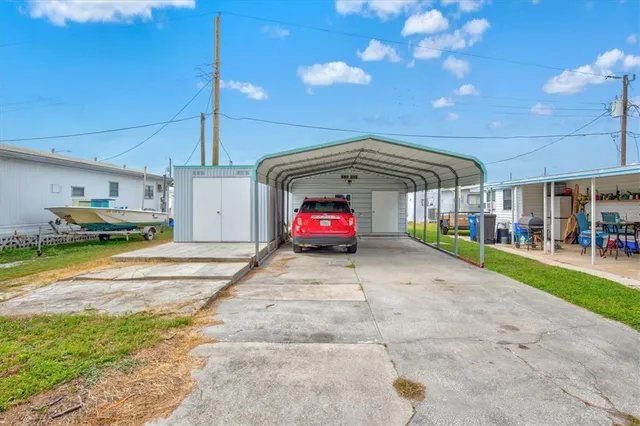 a blue car parked in front of a house