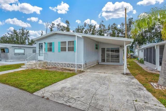 a view of a house with swimming pool and a yard