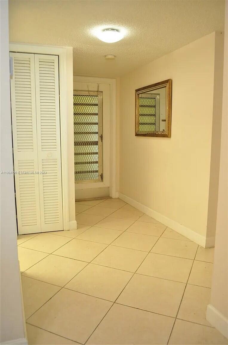 9826 Marina Boulevard, Unit 1015 Boca Raton, FL 33428 - Photo 10 of 12 a view of a livingroom with wooden floor and a bathroom
