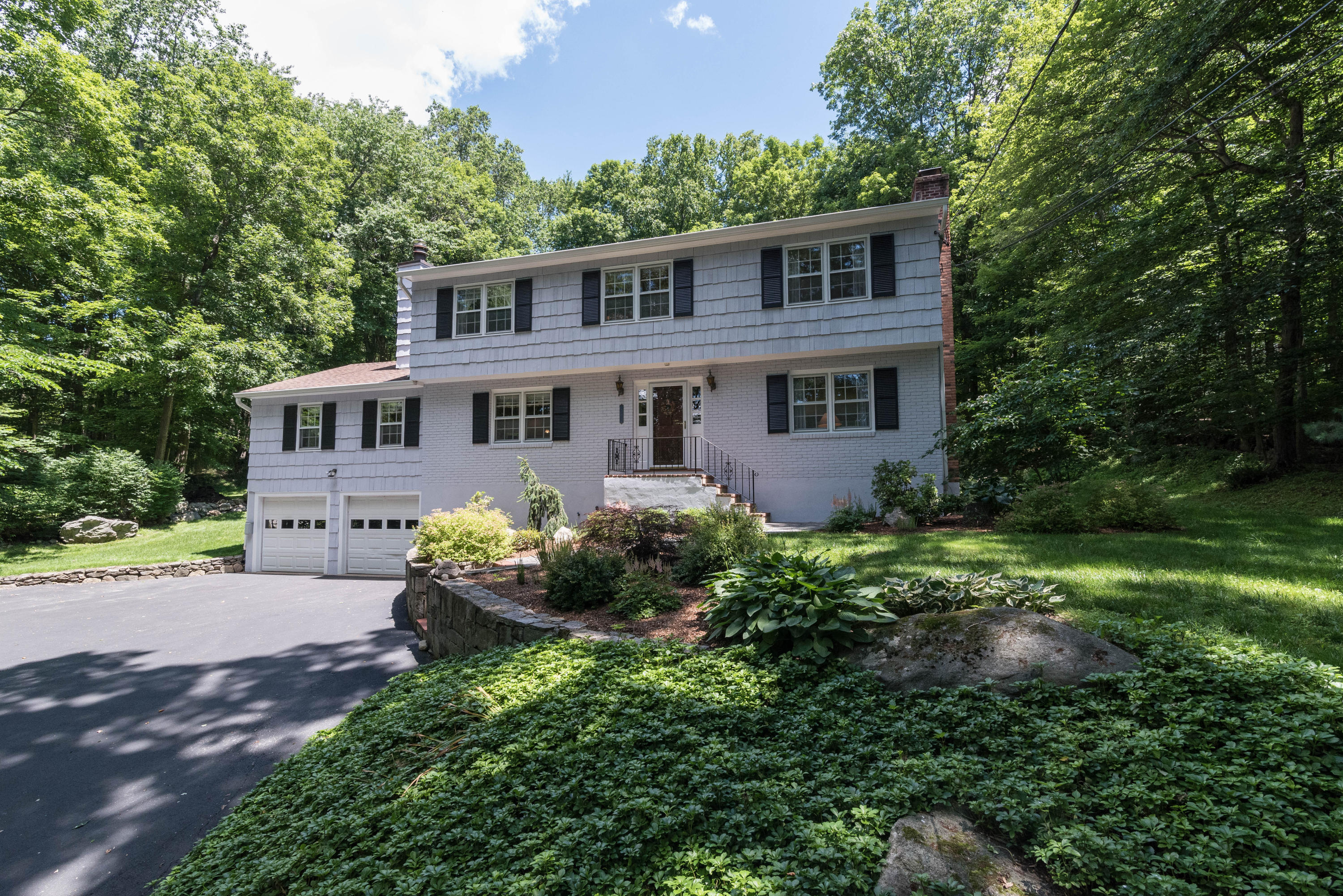 24 Hannahs Road Stamford, CT 06903 - Photo 1 of 28 front view of a house with a garden
