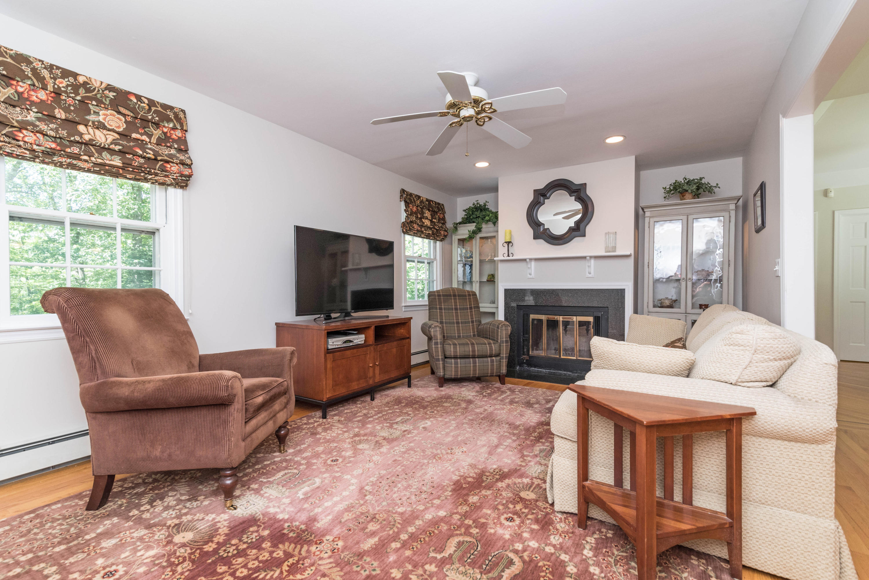 24 Hannahs Road Stamford, CT 06903 - Photo 11 of 28 a living room with furniture a fireplace and a flat screen tv