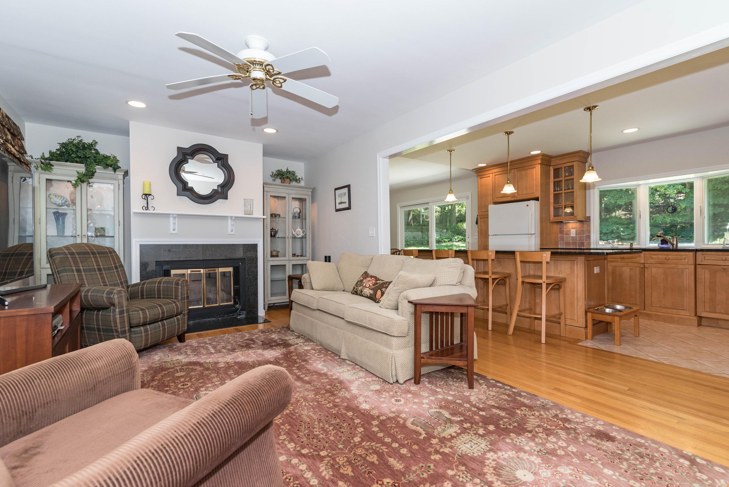 24 Hannahs Road Stamford, CT 06903 - Photo 12 of 28 a living room with furniture a fireplace and a floor to ceiling window