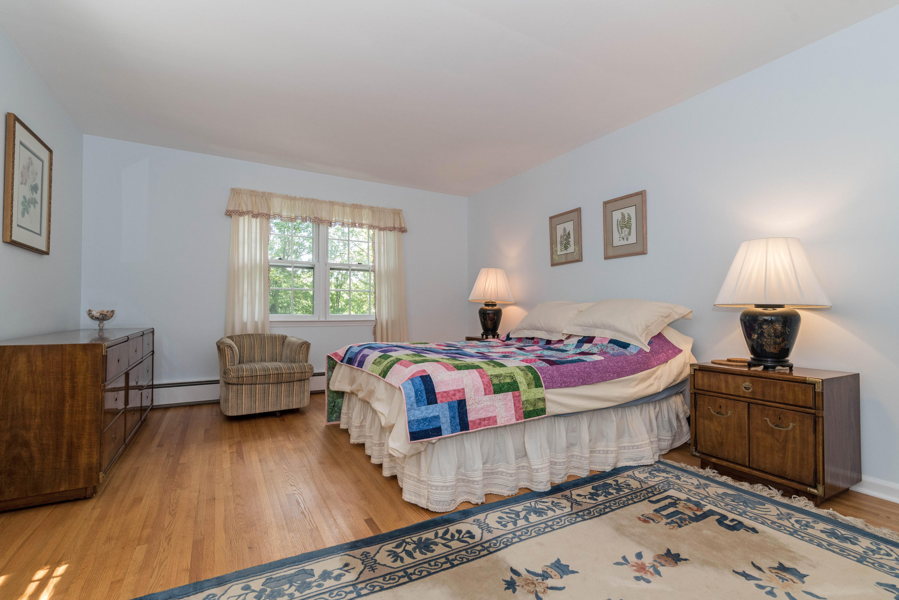 24 Hannahs Road Stamford, CT 06903 - Photo 16 of 28 a bedroom with a bed and wooden floor