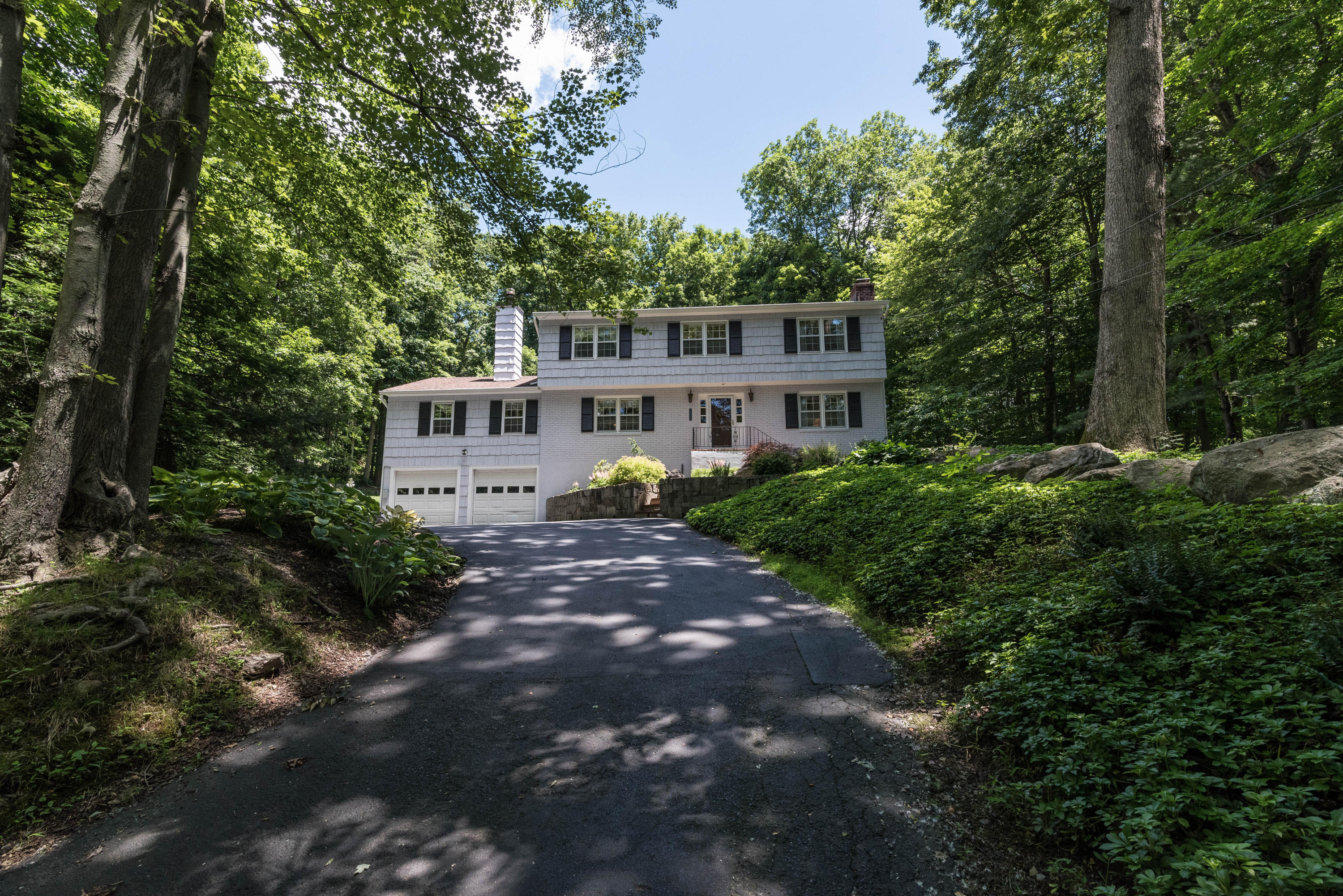 24 Hannahs Road Stamford, CT 06903 - Photo 2 of 28 a view of a house with a yard and tree s