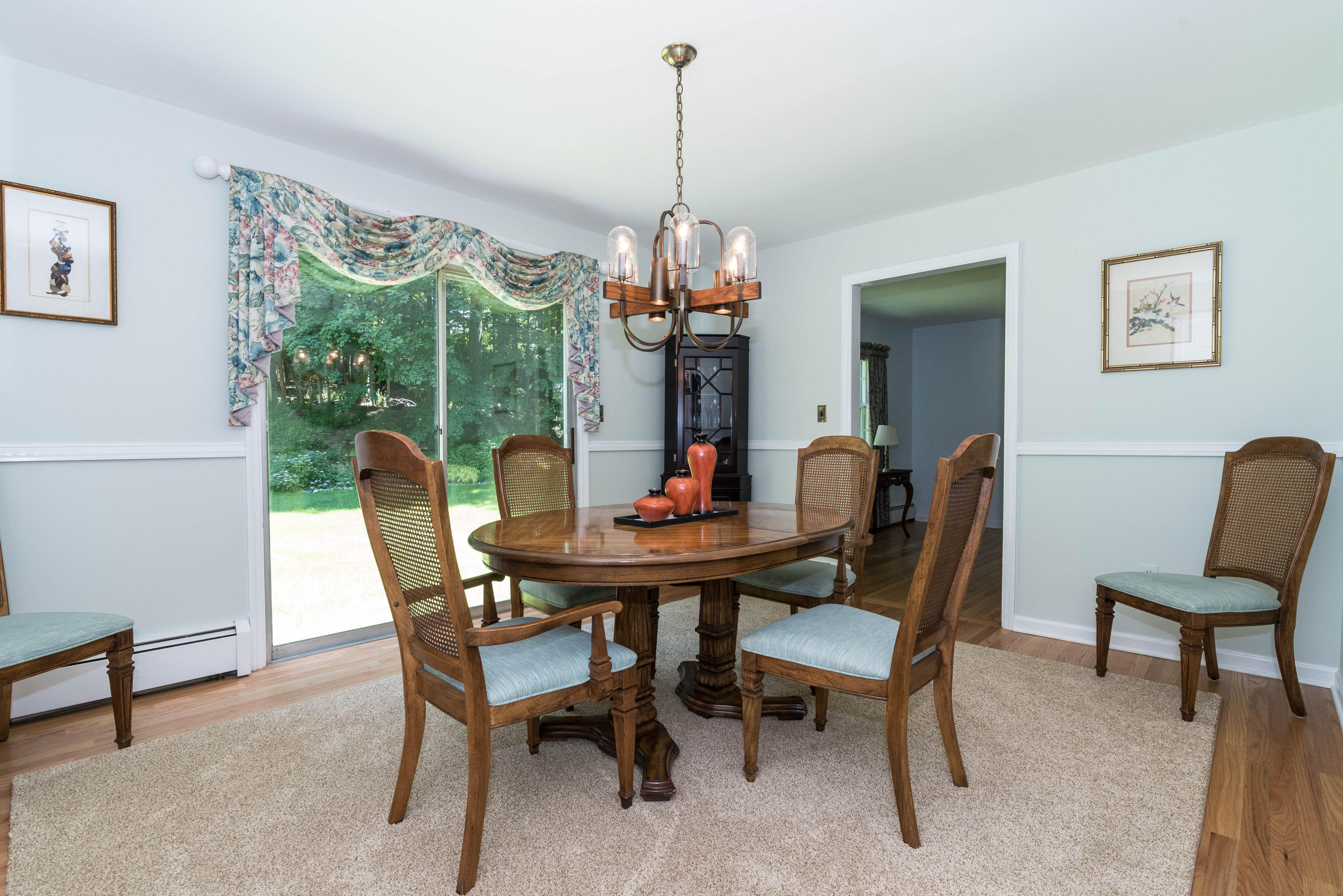24 Hannahs Road Stamford, CT 06903 - Photo 6 of 28 a dining room with furniture a chandelier and a rug
