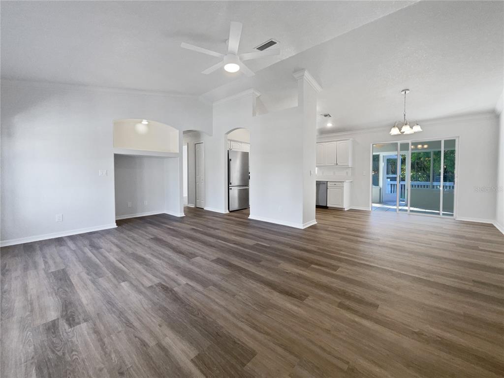 3053 Draper Terrace North Port, FL 34286 - Photo 14 of 31 an empty room with wooden floor and windows