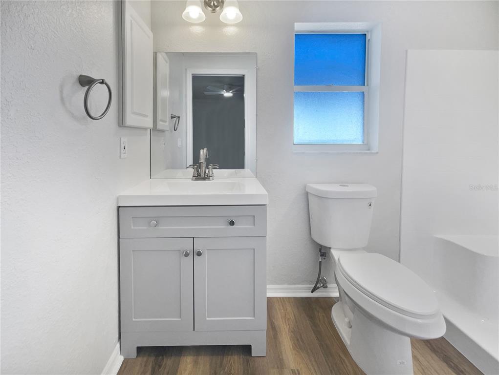 3053 Draper Terrace North Port, FL 34286 - Photo 18 of 31 a bathroom with a toilet a sink a vanity and mirror