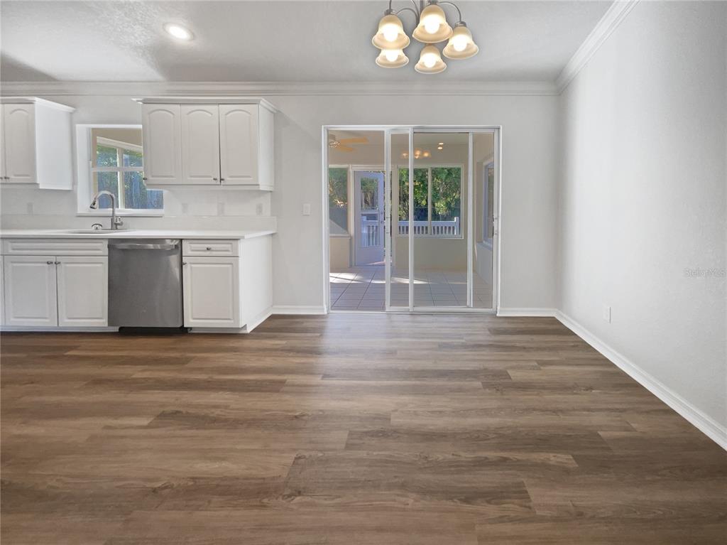 3053 Draper Terrace North Port, FL 34286 - Photo 19 of 31 a view of a kitchen with a sink cabinets and outdoor space