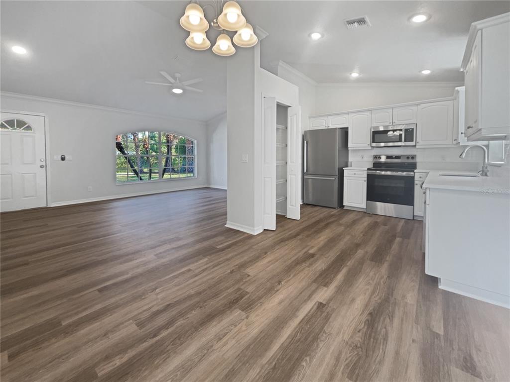 3053 Draper Terrace North Port, FL 34286 - Photo 20 of 31 a kitchen with stainless steel appliances granite countertop a refrigerator a stove and a wooden floors