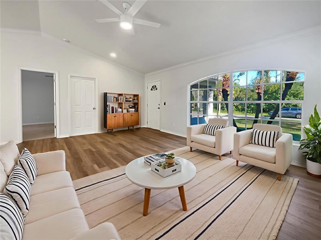 3053 Draper Terrace North Port, FL 34286 - Photo 2 of 31 a living room with furniture and a table