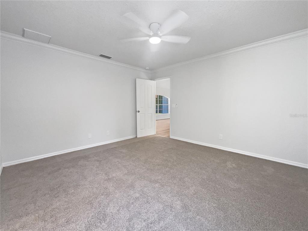 3053 Draper Terrace North Port, FL 34286 - Photo 5 of 31 a view of an empty room with a ceiling fan