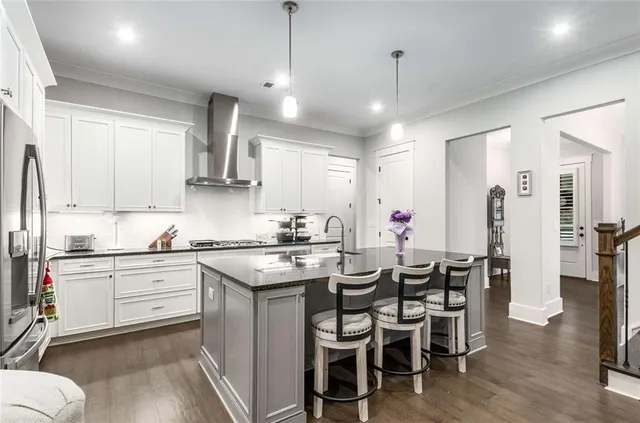 a kitchen with stainless steel appliances a sink and a refrigerator