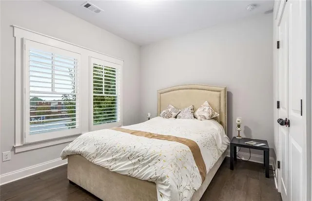 a bathroom with a granite countertop sink toilet and mirror