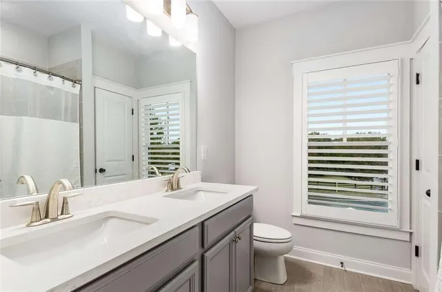 a bedroom with a bed a dresser and a window