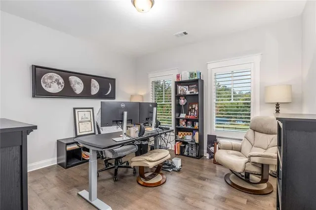a bathroom with a granite countertop sink toilet and a mirror