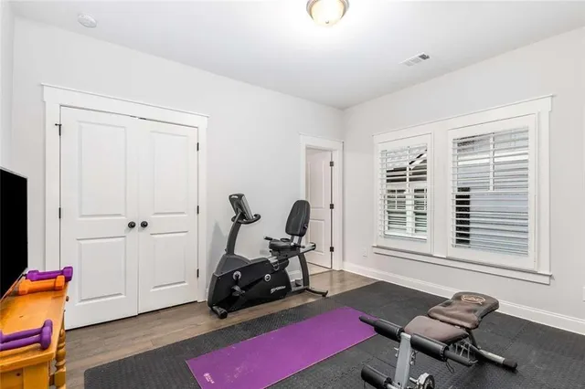 a front view of house with yard and trees around