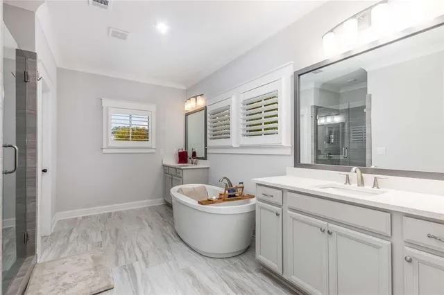 a room with a sink and mirror with wooden floor