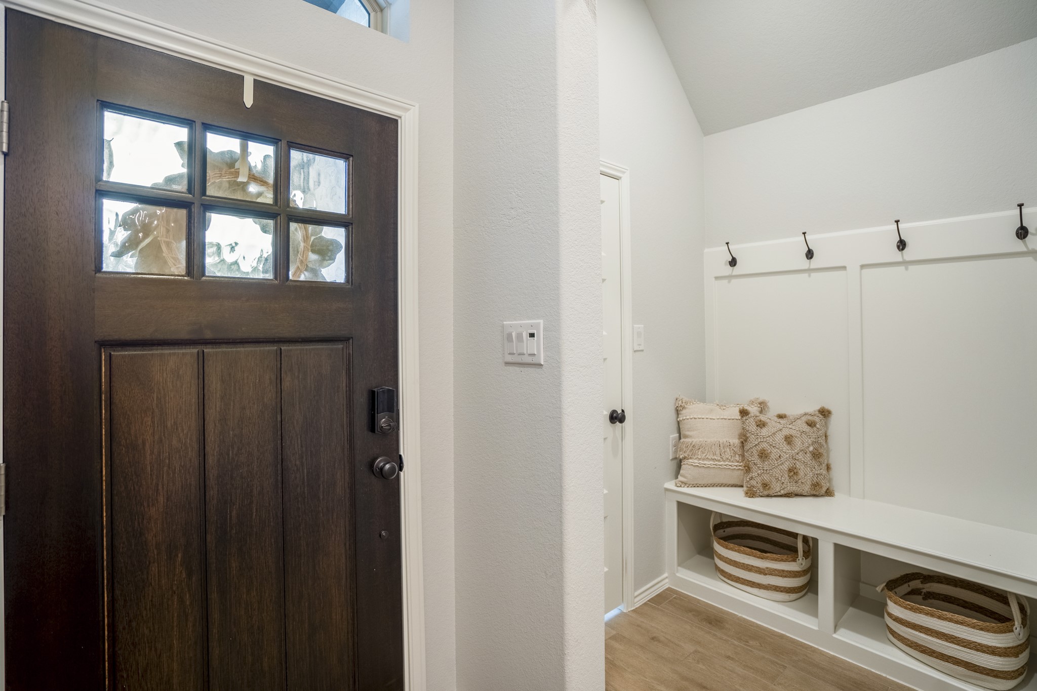 334 Topper Pines Drive Montgomery, TX 77316 - Photo 31 of 49 Just off the front entry, the mud drop zone adds everyday function with bench seating, hooks, and storage below, while the door beside it opens to a walk-in coat closet for even more grab-and-go storage.
