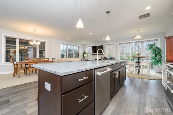a kitchen with stainless steel appliances granite countertop a stove and cabinets