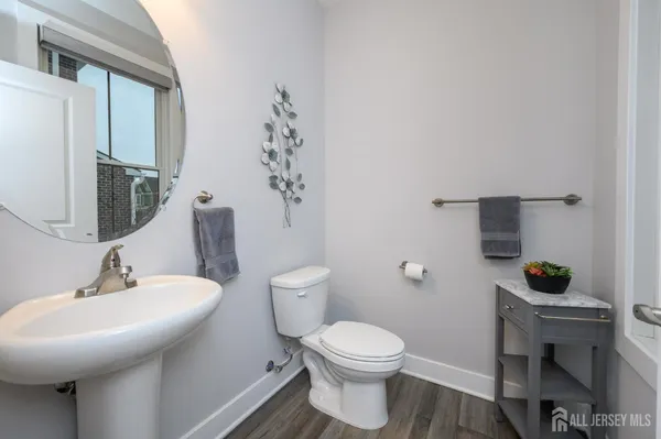 a bathroom with a sink a toilet and a mirror