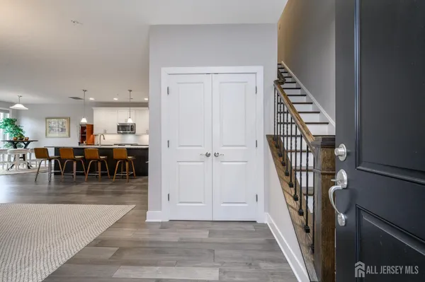 an entryway in a hall with a window and wooden floor