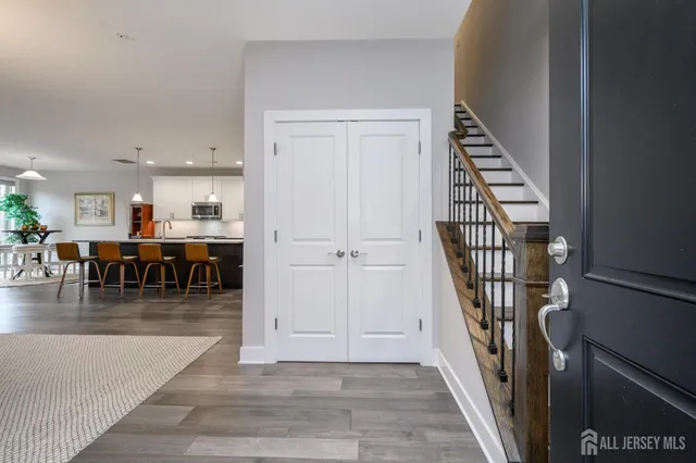 an entryway in a hall with a window and wooden floor