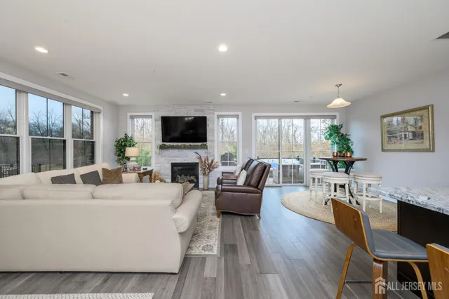 a living room with furniture a large window and a flat screen tv