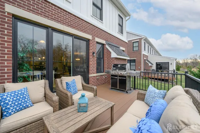 a view of a house with a yard and sitting area