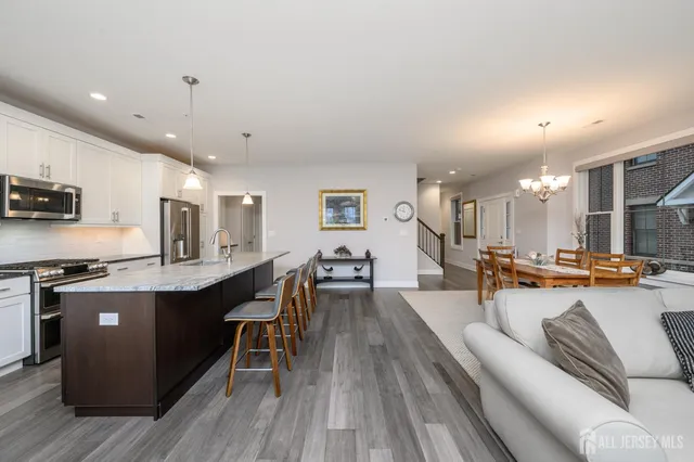 a large kitchen with stainless steel appliances lots of counter space and a sink