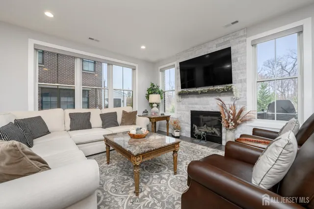 a living room with furniture fireplace and flat screen tv