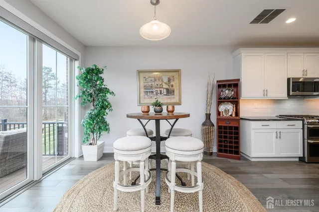 a view of a dining room with furniture and chandelier