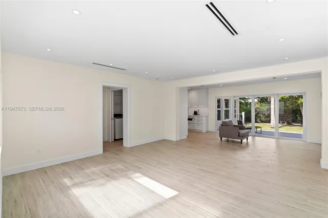 a view of a livingroom with furniture and floor to ceiling window