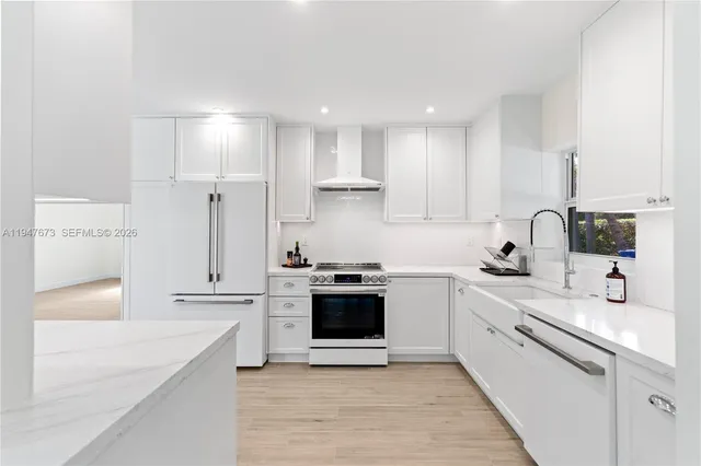 a kitchen with a sink stove top oven and cabinets