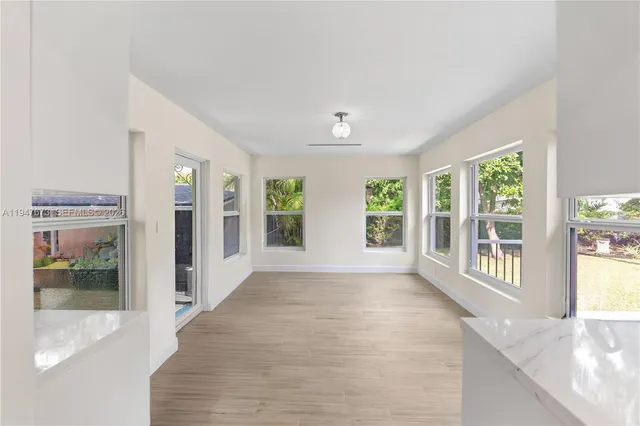 a view of an entryway with wooden floor and windows