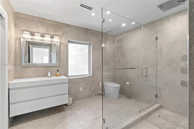 a bathroom with a sink toilet and shower