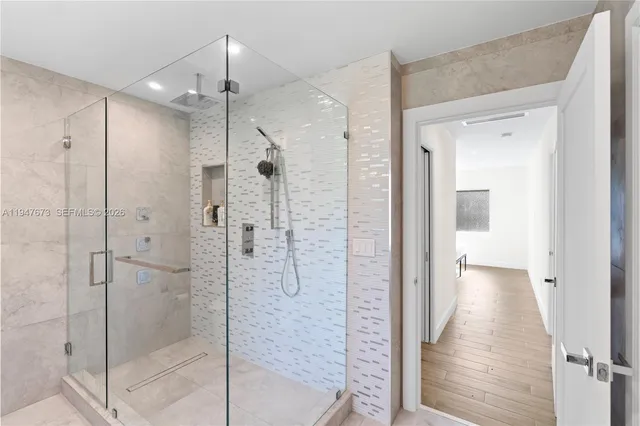 a bathroom with a shower and a sink