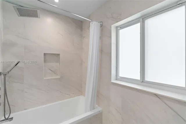 a white bath tub sitting next to a window