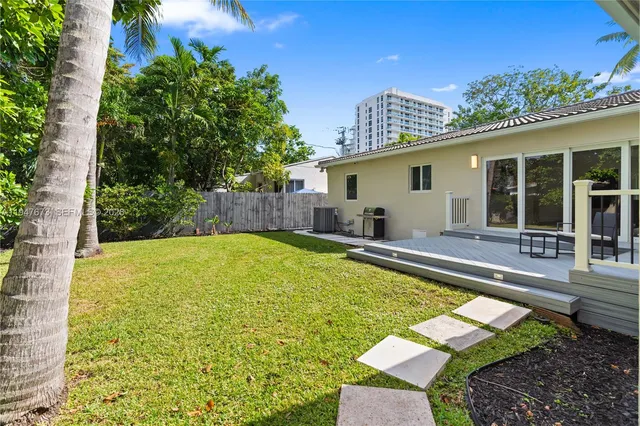 a view of a house with swimming pool and sitting area
