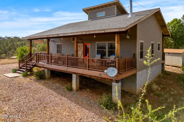 a wooden bench sitting in front of a house