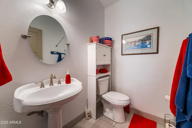 a living room with furniture a rug and a book shelf