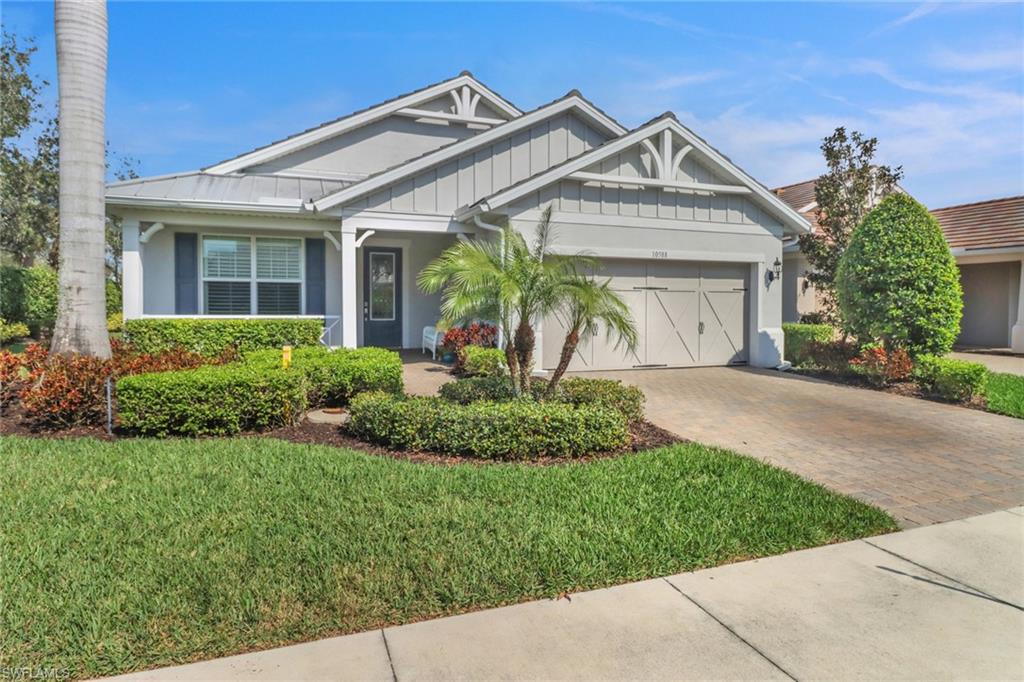 10588 Jackson Square Drive Estero, FL 33928 - Photo 1 of 50 front view of a house with a garden