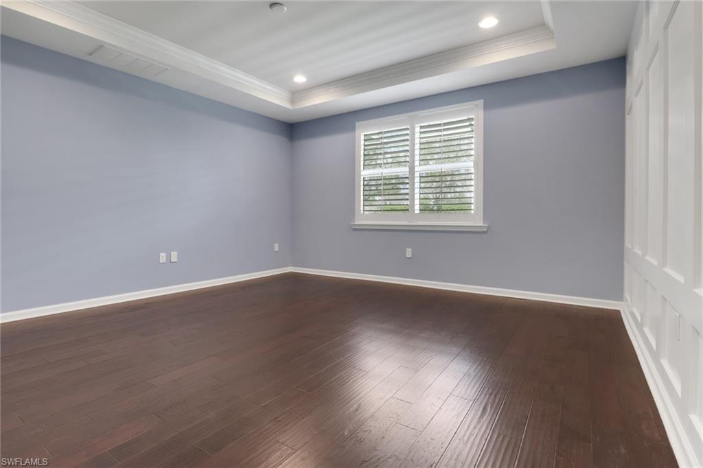 10588 Jackson Square Drive Estero, FL 33928 - Photo 16 of 50 an empty room with wooden floor and windows